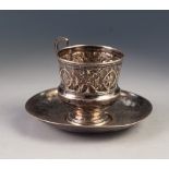 19th CENTURY RUSSIAN SILVER COLOURED METAL CUP with raised 'S' scroll handle, the campana shaped