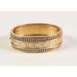 VICTORIAN GOLD COLOURED METAL HINGE OPENING BROAD BANGLE, the top finely pierced with foliate