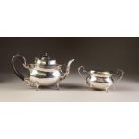 INTER-WAR YEARS SILVER TEAPOT AND MATCHING TWO HANDLED SUGAR BASIN, of rounded oblong form with