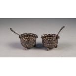 PAIR OF VICTORIAN SMALL CIRCULAR SALT RECEIVERS, repousse with a repeat floral pattern, crimped