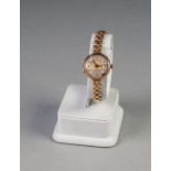 a 9ct GOLD LADY'S WRIST WATCH, on rolled gold linked bracelet (seconds hand detached)