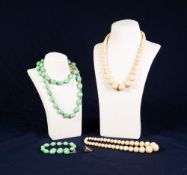 TWO VICTORIAN SINGLE STRAND NECKLACES OF GRADUATED ROUND IVORY BEADS; long necklace of green oval