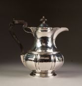 EARLY 20th CENTURY SILVER COFFEE POT of baluster shape with pierced scrolliated rim, blackwood