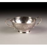 A TWENTIETH CENTURY PERSIAN WHITE METAL SMALL SHALLOW TWO HANDLED BOWL, with engraved decoration,