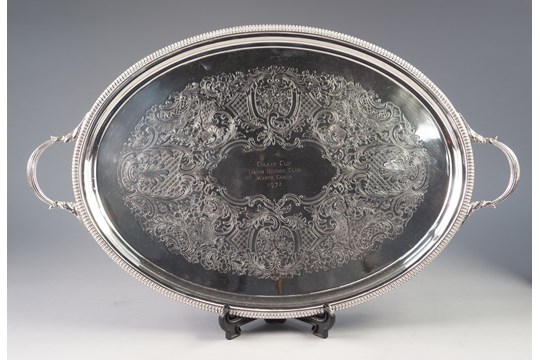 ELECTROPLATED TWO HANDLED PRESENTATION TRAY BY BARKER ELLIS, of oval form with nulled border, reeded
