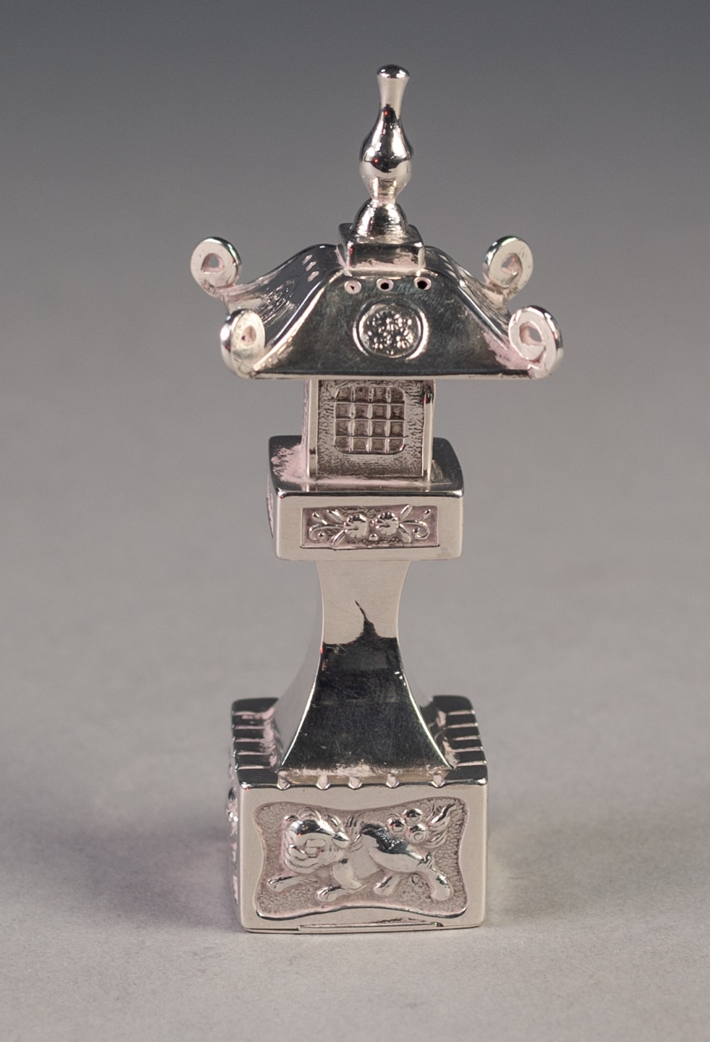 CHINESE STERLING SILVER PAGODA PATTERN PEPPERETTE, with sliding panel to the base, 3 ¼" (8.3cm)