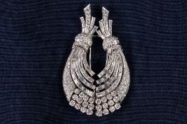 WHITE GOLD AND DIAMOND DOUBLE CLIP BROOCH COMPOSED OF TWO CURVING SPRAYS SET WITH BRILLIANT,