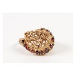 9ct GOLD PIERCED NUGGET PATTERN COCKTAIL RING, set with a curved row of twelve small rubies, 6.5gms,