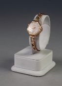 9ct GOLD CASED LADY'S LEDA WRIST WATCH, on 9ct gold linked bracelet, 15.0gms gross, in associated