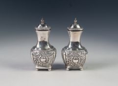 PAIR OF VICTORIAN SILVER PEPPERETTES, the lower portion repousse with flower and rococo scrolls,