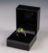 14ct WHITE GOLD RING, set with an oval Peridot, approx 3.48ct, the 'V' shaped shoulders set with