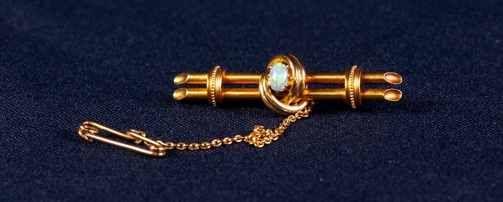 EDWARDIAN 15ct GOLD BROOCH centrally set with an opal, with safety chain, 5.1 gms gross, in case