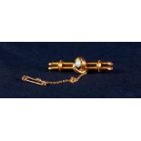 EDWARDIAN 15ct GOLD BROOCH centrally set with an opal, with safety chain, 5.1 gms gross, in case