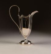 ELEGANT EDWARDIAN SILVER CREAM JUG of hexagonal helmet form with scroll handle, on hexagonal stem