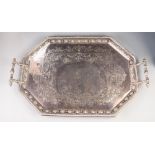 VICTORIAN ELECTROPLATED CANTED RECTANGULAR TWO HANDLED TEA TRAY, the centre engraved with foliate