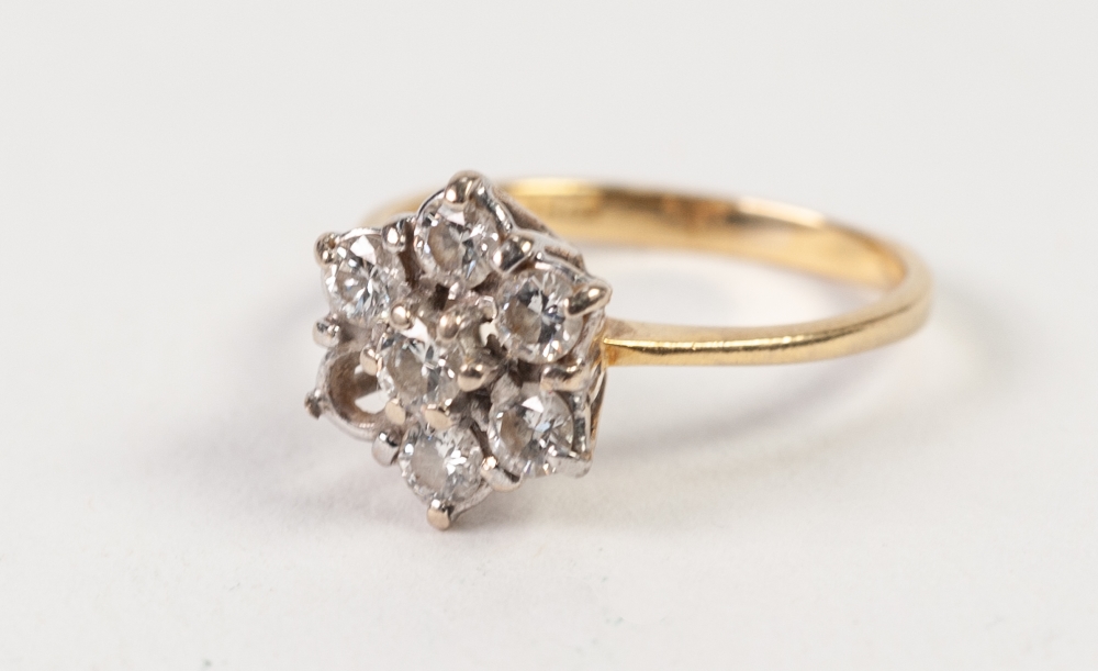 18ct GOLD AND DIAMOND DAISY CLUSTER RING, set with six (of seven) diamonds, London import mark 1990,