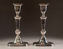 PAIR OF INTER-WAR YEARS WEIGHTED SILVER CANDLESTICKS of rounded-oblong baluster form with