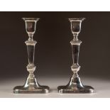 PAIR OF INTER-WAR YEARS WEIGHTED SILVER CANDLESTICKS of rounded-oblong baluster form with