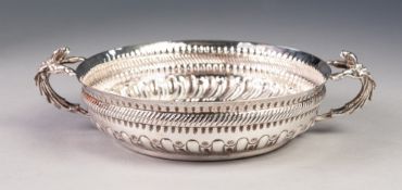 VICTORIAN EMBOSSED SILVER TWO HANDLED SHALLOW DISH, the lower gadroon moulded section set beneath