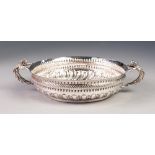 VICTORIAN EMBOSSED SILVER TWO HANDLED SHALLOW DISH, the lower gadroon moulded section set beneath