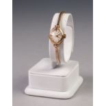 LADY'S 'TALIS' 9ct GOLD WRIST WATCH, with mechanical movement, lozenge shaped silver dial with