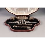 GEORGE V CASED EIGHT PIECE MANICURE SET, comprising: a pair of facet cut small toilet jars with