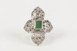 WHITE GOLD COLOURED METAL RING (unmarked) with centre collet set oblong emerald, the surround of