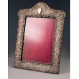 SILVER MOUNTED PHOTOGRAPH FRAME WITH EASEL SUPPORT, pierced and embossed with C scrolls and