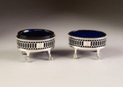 PAIR OF GEORGE III SILVER OVAL SALT CELLARS, one with original blue glass liner, the other a