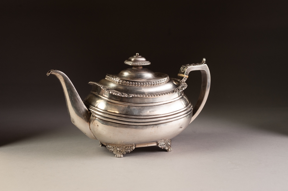 GEORGE IV SILVER TEAPOT of rounded oblong form with gadrooned and shell cornered rim, angular leaf-