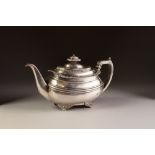 GEORGE IV SILVER TEAPOT of rounded oblong form with gadrooned and shell cornered rim, angular leaf-