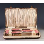 LADY'S ART DECO SILVER AND PINK GUILLOCHE 'SUNBURST' PATTERN ENAMELLED DRESSING TABLE BRUSH SET OF