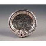 UNMARKED FOREIGN SILVER COLOURED METAL ASHTRAY, with hinged bangle pattern border and engraved