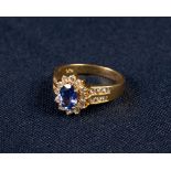 18ct GOLD TANZANITE AND DIAMOND CLUSTER RING, set with an oval tantanzite of medium deep bluish