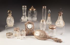 TWELVE VARIOUS SILVER MOUNTED AND TOPPED CUT AND ENGRAVED GLASS DRESSING TABLE JARS, scent spray/