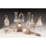 TWELVE VARIOUS SILVER MOUNTED AND TOPPED CUT AND ENGRAVED GLASS DRESSING TABLE JARS, scent spray/