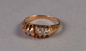 18ct GOLD RING WITH A LOZENGE SHAPED SETTING OF THREE TINY DIAMONDS AND ONE WHITE STONE, the