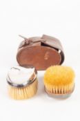 A LEATHER CASED PAIR OF SILVER BACKED GENTLEMEN'S HAIR BRUSHES, Birmingham 1910
