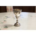 A SILVER COLOURED METAL WINE GOBLET, THE FILIGREE DECORATED BOWL SET WITH FIVE TURQUOISE, 5"