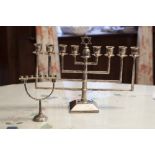AN ELECTROPLATE MENORAH WITH ANGULAR BRANCHES WITH COLUMN AND SQUARE BASE, 8 ½" HIGH AND THE LOOSE