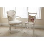 A WHITE PAINTED WOOD FRENCH STYLE OPEN ARMCHAIR WITH UPHOLSTERED BACK PANEL, ELBOW RESTS AND SEAT