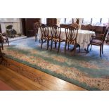 A LARGE WASHED CHINESE CARPET WITH GREEN GROUND, AUBUSSON DESIGN, OFF-WHITE AND FLORAL CENTRE OVAL