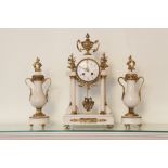 A FRENCH WHITE MARBLE AND GILT MANTEL CLOCK GARNITURE, VIZ DRUM CASED CLOCK ON FOUR COLUMN SUPPORTS,