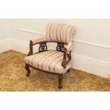 VICTORIAN MAHOGANY TUB SHAPED LOW SEATED NURSING CHAIR UPHOLSTERED AND COVERED IN STRIPED SILK