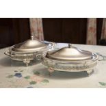 A PAIR OF ELECTROPLATE TWO HANDLED OVAL ENTRÉE DISHES WITH PIERCED GALLERY SIDES, OVAL GLASS