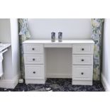 A MODERN WHITE PAINTED WOOD DOUBLE PEDESTAL DRESSING TABLE OF SIX DRAWERS