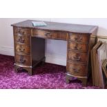 A FIGURED MAHOGANY DOUBLE PEDESTAL DESK WITH INLET LEATHER TOP, SEVEN DRAWERS TO THE SERPENTINE