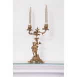 A GILT METAL TWO BRANCH CANDELABRUM WITH MUSICIAN FIGURE TO THE BASE, 12 ¾" HIGH