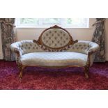 VICTORIAN FLORAL CARVED WALNUT SHEW-WOOD FRAMED DRAWING ROOM SETTEE, BUTTON UPHOLSTERED IN BLUE