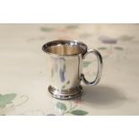 A SILVER CHRISTENING MUG, PLAIN AND TUCKED-IN, ON STEP DOMED BASE, 'C' SCROLL HANDLE, MAKERS